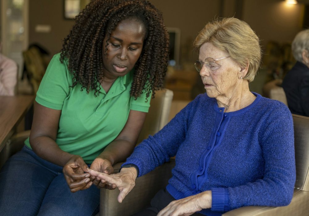 Helper caring for elderly lady